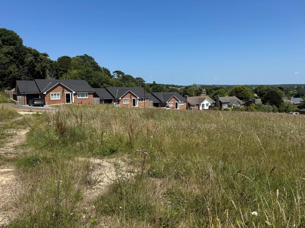 Lot: 33 - OVER THREE-QUARTERS OF AN ACRE FREEHOLD LAND WITH PLANNING FOR SEVEN DETACHED BUNGALOWS - A View of the Site and in the Background the Last Bungalows Built on the Site